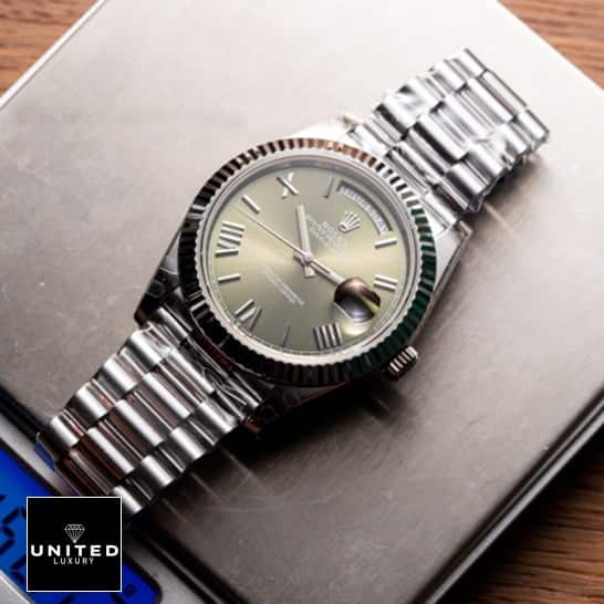 Rolex Olive Green Replica 11 Rolex Day-Date 228239-0033 Stainless Steel Replica On the table