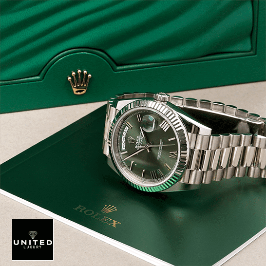 Rolex Olive Green Replica 5 Rolex Day-Date 228239-0033 Romen Numerial Olive Green Dial Replica in front of Rolex Box